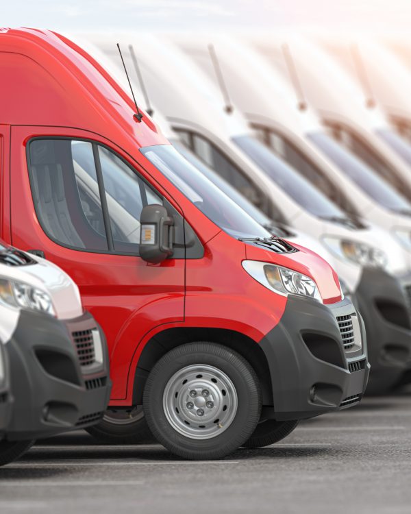 Red delivery van in a row of white vans. Best express delivery and shipemt service concept.